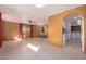 Bright living room featuring tile floors, wood paneled walls, with arched openings to other rooms at 7654 E Calypso Ave, Mesa, AZ 85208