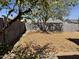 View of a large backyard covered in fallen leaves enclosed by a brick wall at 822 W El Alba Way, Chandler, AZ 85225