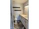 Well-lit bathroom featuring a modern vanity with marble top, updated fixtures, and floating wood shelves at 822 W El Alba Way, Chandler, AZ 85225