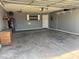 Spacious garage with gray painted walls, utility sink, and storage shelves for organization at 822 W El Alba Way, Chandler, AZ 85225