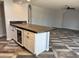 A kitchen island with seating, a built in wine cooler, and concrete countertops complements the home at 822 W El Alba Way, Chandler, AZ 85225