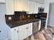 Updated kitchen featuring white cabinets, concrete countertops, stainless steel appliances, and mixed wood flooring at 822 W El Alba Way, Chandler, AZ 85225