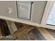 A utility access panel with unique multi-tone wood flooring and white trim detail near an exterior door at 822 W El Alba Way, Chandler, AZ 85225