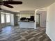 Open-concept living space with decorative flooring, white cabinets, and a view into the updated kitchen at 822 W El Alba Way, Chandler, AZ 85225