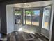Bright living room with large bay window and multi-tone wood-look flooring looking out to the backyard at 822 W El Alba Way, Chandler, AZ 85225