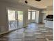 Living area with backyard view via sliding glass door, decorative floors, and view into the updated kitchen at 822 W El Alba Way, Chandler, AZ 85225