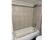 Bathroom tile shower featuring earth tone tile and updated showerhead fixtures at 822 W El Alba Way, Chandler, AZ 85225