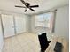 Bedroom with closet, natural light, and neutral tile flooring at 8402 N 105Th Ln, Peoria, AZ 85345