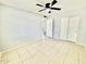 A neutral bedroom with tile floor and closet at 8402 N 105Th Ln, Peoria, AZ 85345