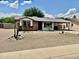 Charming single-story home with a covered carport and low maintenance desert landscaping at 8402 N 105Th Ln, Peoria, AZ 85345