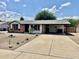 Charming single-story home with a covered carport and low maintenance desert landscaping at 8402 N 105Th Ln, Peoria, AZ 85345