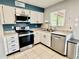 Well-lit kitchen featuring stainless steel appliances, granite countertops, and clean white cabinetry at 8402 N 105Th Ln, Peoria, AZ 85345