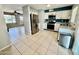 Bright kitchen featuring stainless steel appliances, granite counters and neutral tile flooring at 8402 N 105Th Ln, Peoria, AZ 85345