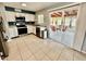 Bright kitchen with stainless appliances, white cabinetry, and slider door to the patio at 8402 N 105Th Ln, Peoria, AZ 85345