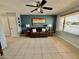 Spacious living room featuring tile floors, a ceiling fan, and a window providing natural light at 8402 N 105Th Ln, Peoria, AZ 85345