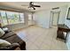 Inviting living room featuring neutral tile flooring, bright windows and ample natural light at 8402 N 105Th Ln, Peoria, AZ 85345