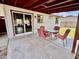 The covered patio features outdoor dining furniture and fan at 8402 N 105Th Ln, Peoria, AZ 85345