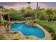 Aerial view of the pool and backyard oasis, desert landscape, and waterfall feature at 8526 E Hackamore Dr, Scottsdale, AZ 85255