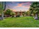 Expansive backyard featuring lush green grass, mature trees, and a sparkling pool area at 8526 E Hackamore Dr, Scottsdale, AZ 85255