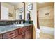 Bathroom features a vanity with granite countertops, framed mirror, and tiled shower/tub combo at 8526 E Hackamore Dr, Scottsdale, AZ 85255