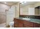 Bathroom features a walk-in shower, vanity with granite countertops, and tiled floors at 8526 E Hackamore Dr, Scottsdale, AZ 85255