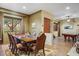 Elegant dining room with a large wooden table, decorative rug, and a view to a billiards room at 8526 E Hackamore Dr, Scottsdale, AZ 85255