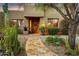 Inviting single-story home with well-maintained landscaping and a stone walkway leading to the front door at 8526 E Hackamore Dr, Scottsdale, AZ 85255