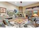 Inviting living room with cozy seating, fireplace, and views of the beautiful backyard through the windows at 8526 E Hackamore Dr, Scottsdale, AZ 85255