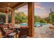 Relaxing patio with chairs and fire pit overlooking a refreshing pool and lush desert landscape at 8526 E Hackamore Dr, Scottsdale, AZ 85255