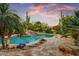Beautiful pool with waterfall feature and lush landscaping creating a backyard oasis at 8526 E Hackamore Dr, Scottsdale, AZ 85255