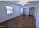 Bedroom with wood-look flooring, window, ceiling fan and closets at 8558 E Indian School Rd # A, Scottsdale, AZ 85251