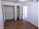 Bedroom with wood-look flooring and closet with open doors at 8558 E Indian School Rd # A, Scottsdale, AZ 85251
