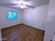 Bedroom with wood-look flooring, window, and ceiling fan at 8558 E Indian School Rd # A, Scottsdale, AZ 85251