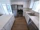 Bright kitchen with white cabinets, stainless steel appliances, and granite countertops at 8558 E Indian School Rd # A, Scottsdale, AZ 85251