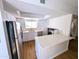 Modern white kitchen with stainless steel appliances, quartz countertops, and a bright window at 8558 E Indian School Rd # A, Scottsdale, AZ 85251