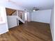 Bright living room featuring wood floors, white walls, and an open staircase at 8558 E Indian School Rd # A, Scottsdale, AZ 85251