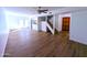 Spacious living room with wood floors, staircase, and access to the kitchen and outdoor patio at 8558 E Indian School Rd # A, Scottsdale, AZ 85251