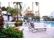 Community pool area with lounge chairs and lush landscaping at 8558 E Indian School Rd # A, Scottsdale, AZ 85251