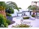 Community pool area featuring lounge chairs and palm trees at 8558 E Indian School Rd # A, Scottsdale, AZ 85251