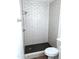 Shower with white subway tile and black honeycomb tile floor at 8558 E Indian School Rd # A, Scottsdale, AZ 85251
