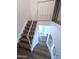 Staircase with wooden steps, a white banister, and wood-look flooring at 8558 E Indian School Rd # A, Scottsdale, AZ 85251