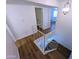 Staircase with wood flooring, white walls, and a modern chandelier at 8558 E Indian School Rd # A, Scottsdale, AZ 85251