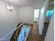 Staircase with wood flooring, white walls, and an overhead light fixture at 8558 E Indian School Rd # A, Scottsdale, AZ 85251