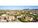 Wide aerial perspective of a suburban neighborhood nestled amidst desert landscape and majestic mountain views at 9231 W Bent Tree Dr, Peoria, AZ 85383