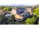 Aerial view of a backyard with solar panels, patio, pergola, lush landscaping, and desert accents at 9231 W Bent Tree Dr, Peoria, AZ 85383