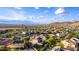 Scenic aerial view of a suburban neighborhood with desert landscaping, mountain views, and community amenities at 9231 W Bent Tree Dr, Peoria, AZ 85383