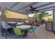 Outdoor kitchen with BBQ, bar seating, gas grill, and fire pit under a pergola at 9231 W Bent Tree Dr, Peoria, AZ 85383
