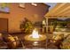 Cozy backyard area featuring a brick fire pit and comfortable seating under the pergola at 9231 W Bent Tree Dr, Peoria, AZ 85383