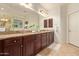 Spacious primary bathroom features a granite countertop, double sinks, and ample storage at 9231 W Bent Tree Dr, Peoria, AZ 85383