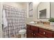 Bathroom featuring a vanity with granite countertops and dark wood cabinets, alongside a toilet and shower at 9231 W Bent Tree Dr, Peoria, AZ 85383